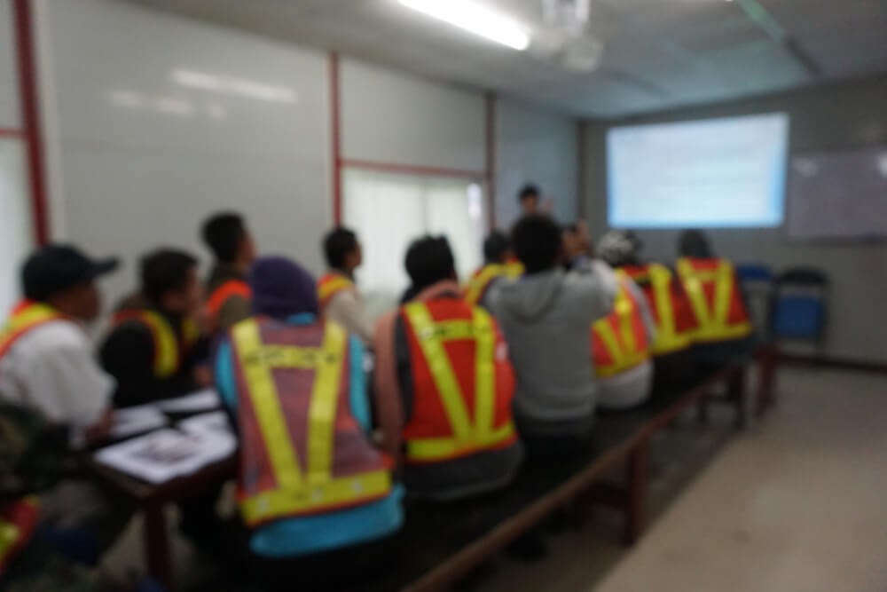 Group of workers on a job site discussing theft prevention on a construction site